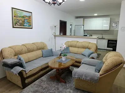 a living room with two couches and a table at Entire house floor - 2-Bedroom Cozy & Peaceful Apartment in Podgorica