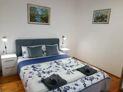 a bedroom with a bed with two hats on it at Entire house floor - 2-Bedroom Cozy & Peaceful Apartment in Podgorica