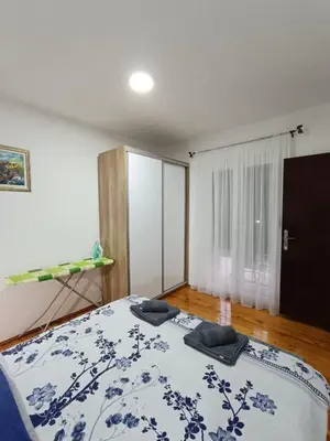 a bedroom with a bed with two pillows on it at Entire house floor - 2-Bedroom Cozy & Peaceful Apartment in Podgorica