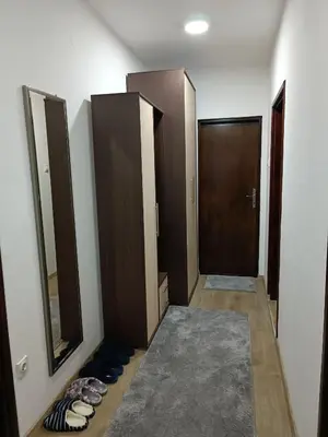 a hallway with doors and shoes in a room at Entire house floor - 2-Bedroom Cozy & Peaceful Apartment in Podgorica