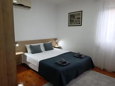 a bedroom with a bed with two hats on it at Entire house floor - 2-Bedroom Cozy & Peaceful Apartment in Podgorica