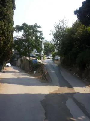 an empty street with a sign on the side of the road at Family House Milic in Ulcinj in Ulcinj