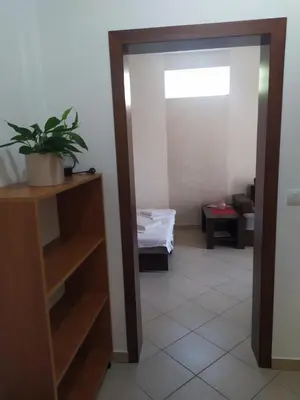 a room with a door open to a room with a plant at Family House Milic in Ulcinj in Ulcinj
