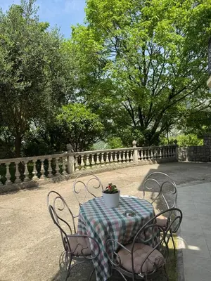 a table with chairs and a table with a flower pot on it at Midpoint in Kotor