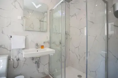 a bathroom with a sink and a shower at Pržno Bay in Sveti Stefan