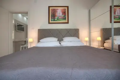 a bedroom with a large bed with two pillows at Pržno Bay in Sveti Stefan