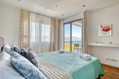 a bedroom with a bed and a large window at Villa Azure Krimovica Kotor in Krimovice