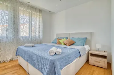 a bedroom with a bed with towels on it at Villa Azure Krimovica Kotor in Krimovice