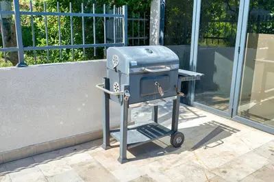 a blue stove on a cart in front of a building at Villa Azure Krimovica Kotor in Krimovice