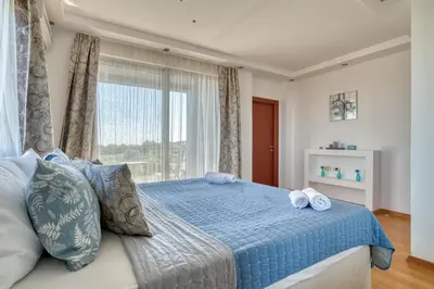 a bedroom with a blue bed with a window at Villa Azure Krimovica Kotor in Krimovice