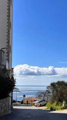 a car parked in a parking lot next to the ocean at Orhid apartment Becici one in Budva