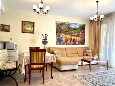 a living room with a couch and a painting on the wall at Orhid apartment Becici one in Budva