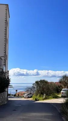 an empty street with a view of the ocean at Orhid apartment Becici one in Budva