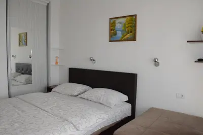 a bedroom with a bed and a picture on the wall at Studios Seaview in Dobra Voda