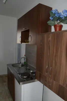 a small kitchen with a sink and a stove at Studios Seaview in Dobra Voda