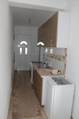 a kitchen with a sink and a stove top oven at Studios Seaview in Dobra Voda