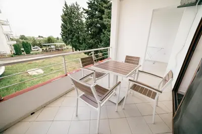 a table and chairs on a balcony with a view at Apartments Contessa in Ulcinj