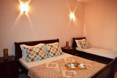a bedroom with two beds and two lights on the wall at Apartments Contessa in Ulcinj