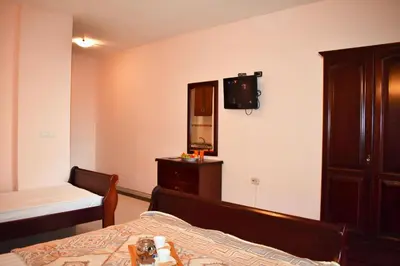 a bedroom with a bed and a dresser and a mirror at Apartments Contessa in Ulcinj