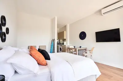 a bedroom with a white bed with orange pillows at Casa Collection in Tivat