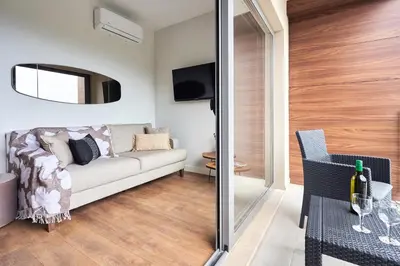 a living room with a couch and a tv at Casa Collection in Tivat