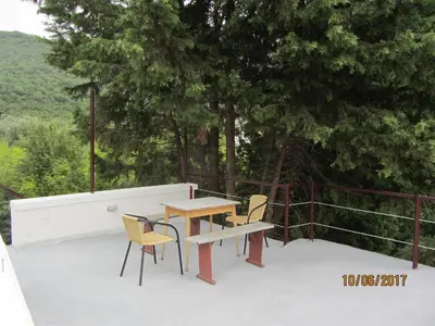 a table and chairs sitting on top of a roof at Holiday Home Idyllic Cottage in Čanj
