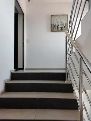 a staircase in a house with a painting on the wall at Apartmani Sutomore Tri Palme in Sutomore