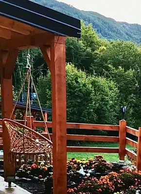 a wooden fence with a bench in a garden at Oasis of Peace in Cetinje