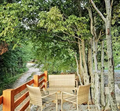 a wooden table and chairs next to a fence at Oasis of Peace in Cetinje