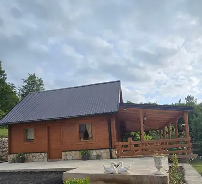 a large wooden cabin with a metal roof at Oasis of Peace in Cetinje
