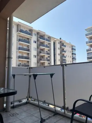 a balcony with a table and some buildings at NADJA Apartman City Kvart in Kruševac