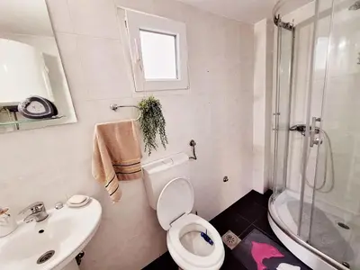 a bathroom with a toilet and a sink and a shower at Melody apartment in Podgorica