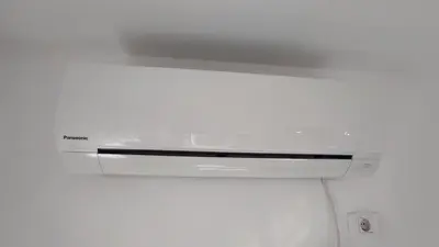 a white stove top oven in a white room at Allurian Apartment - City kvart in Podgorica