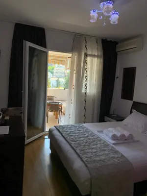 a bedroom with a bed with two towels on it at Budva apartman Centar in Budva