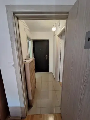 a hallway leading to a room with a black door at Budva apartman Centar in Budva