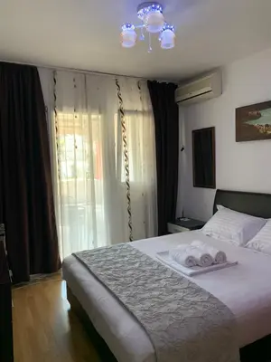 a bedroom with a bed with two towels on it at Budva apartman Centar in Budva