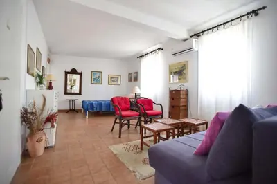 a living room with a blue couch and red chairs at OLD TOWN 5 apartment in Budva