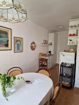 a kitchen and dining room with a table and chairs at OLD TOWN 5 apartment in Budva