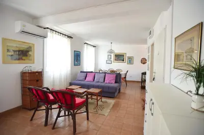 a living room with a couch and a table and chairs at OLD TOWN 5 apartment in Budva