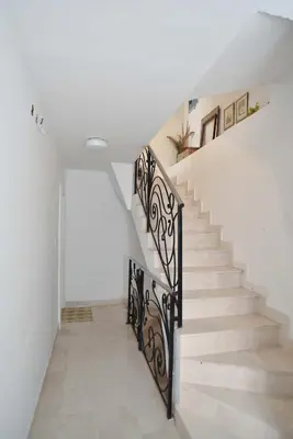 a staircase in a house with a white wall at OLD TOWN 5 apartment in Budva