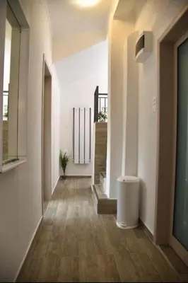 a hallway with white walls and wooden floors at Budva OLD TOWN 4 apartment in Budva