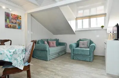 a living room with two blue couches and a table at Budva OLD TOWN 4 apartment in Budva