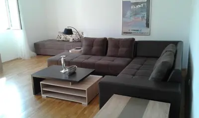 a living room with a couch and a coffee table at Oro Apartments in Petrovac na Moru