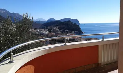 a balcony with a view of the ocean and mountains at Oro Apartments in Petrovac na Moru