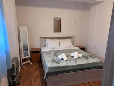 a bedroom with a bed with two towels on it at Guest House Garden in Budva