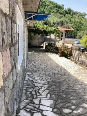 a stone walkway next to a building at Guest House Garden in Budva