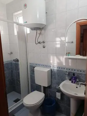 a bathroom with a toilet and a sink at Guest House Garden in Budva