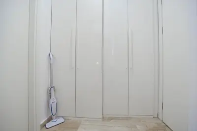 a room with four white closets with a whisk at PREMIUM Tre canne apart 
