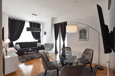 a living room with a glass table and chairs at Luxury one bedroom apartment in beachfront apart Hotel in Budva