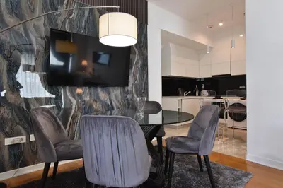 a dining room with a table and chairs at Luxury one bedroom apartment in beachfront apart Hotel in Budva